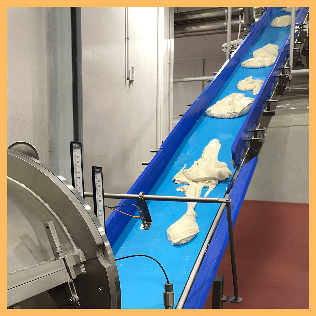 Baked wirecut cookies exiting out of an RBS tunnel oven.